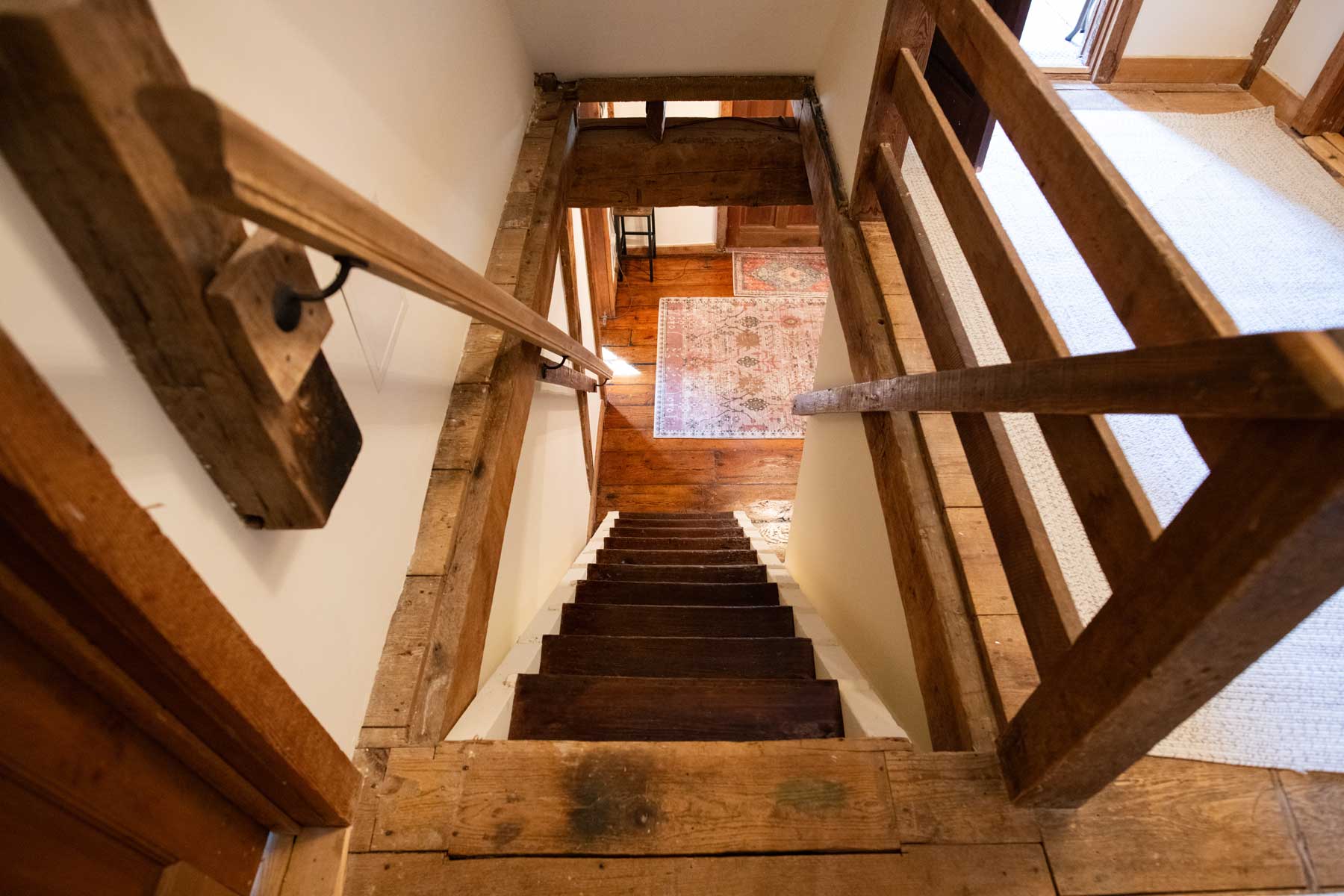 Historic grist mill staircase to bedrooms on second floor of Mill House