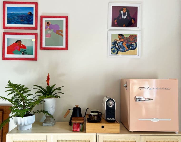 Credenza with potted plants, electric tea kettle, coffee maker, and vintage style pink mini fridge.