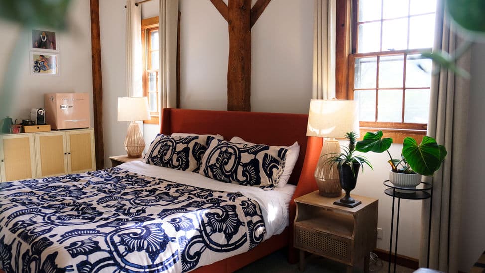King-size bed with upholstered headboard flanked by nightstands with table lamps.