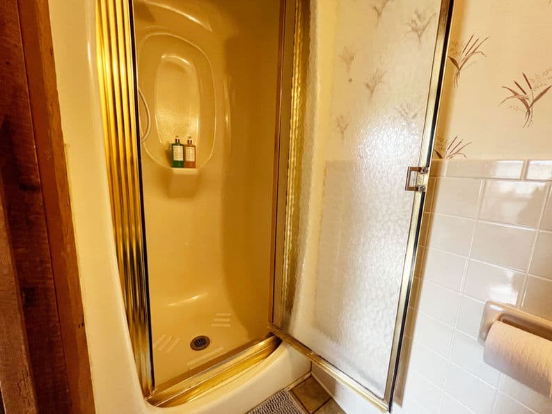 Stand-up shower with glass door.