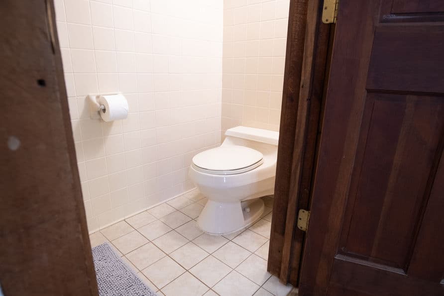 Bathroom with tiled floor and toilet.