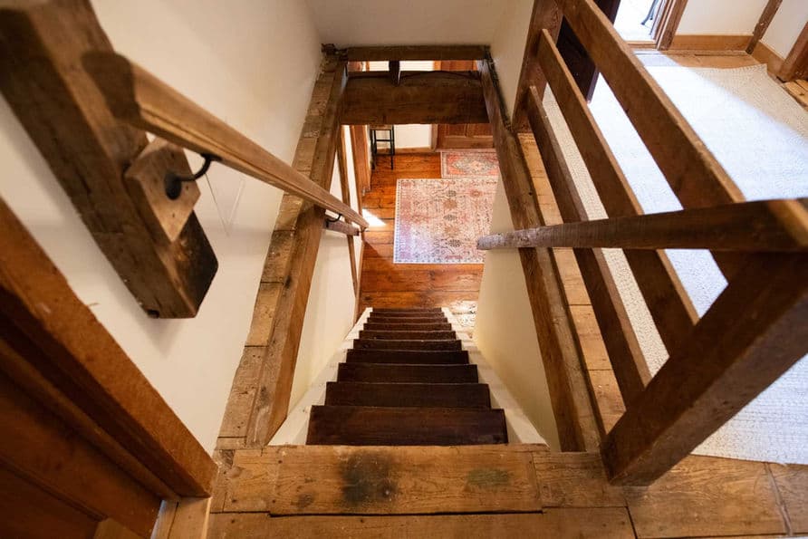 Bird's eye view from the top of historic grist mill staircase to first floor.