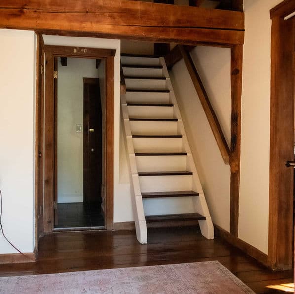 The historic grist mill staircase leading to the second floor from the first.